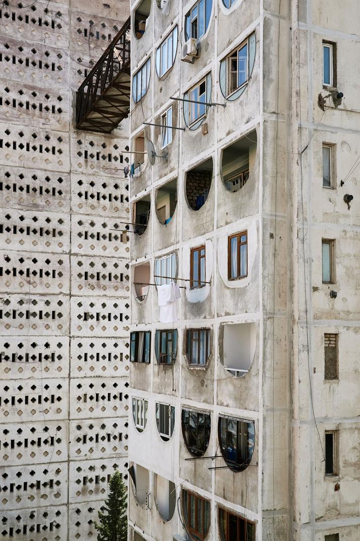 The association of Brutalist architecture with the Soviet Union stems from the USSR's wide adoption of Brutalist styles and building methods during its postwar reconstruction and urban expansion. This connection reflects practical needs, imported techniques, centralized planning, and ideological goals in Soviet architecture from the 1950s through the Brezhnev era.