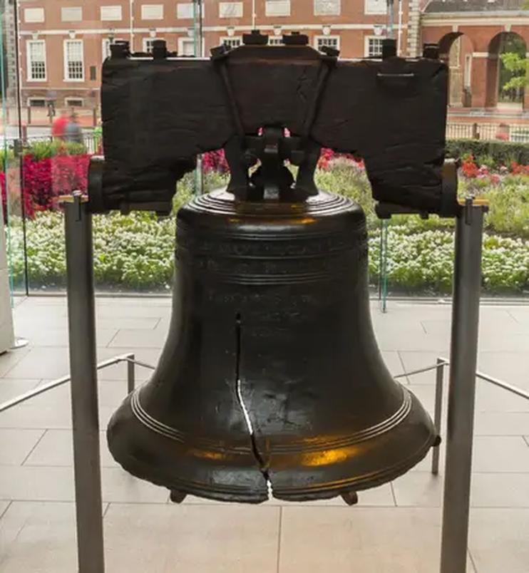 The Liberty Bell is cracked due to a combination of original casting flaws, alloy brittleness, and defects introduced during its re-casting. Initially, the bell cracked on its first test ring in 1752 because of a brittle alloy composition. Subsequent repair attempts failed, and when it was re-cast locally, the new casting introduced more impurities and inconsistencies in the alloy. Over time, these weaknesses caused the bell to crack officially in 1838.